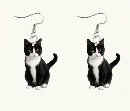 Cat-shaped earrings on a white background