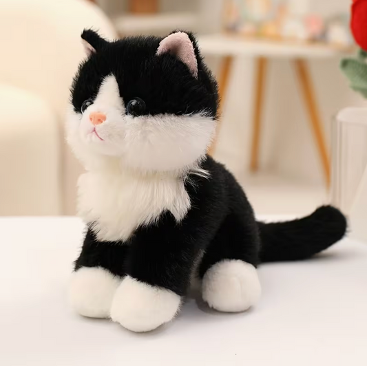 Black and white tuxedo cat plush stuffed animal with fluffy white paws, pink nose, and long black tail, measuring approximately 8.66 inches tall.