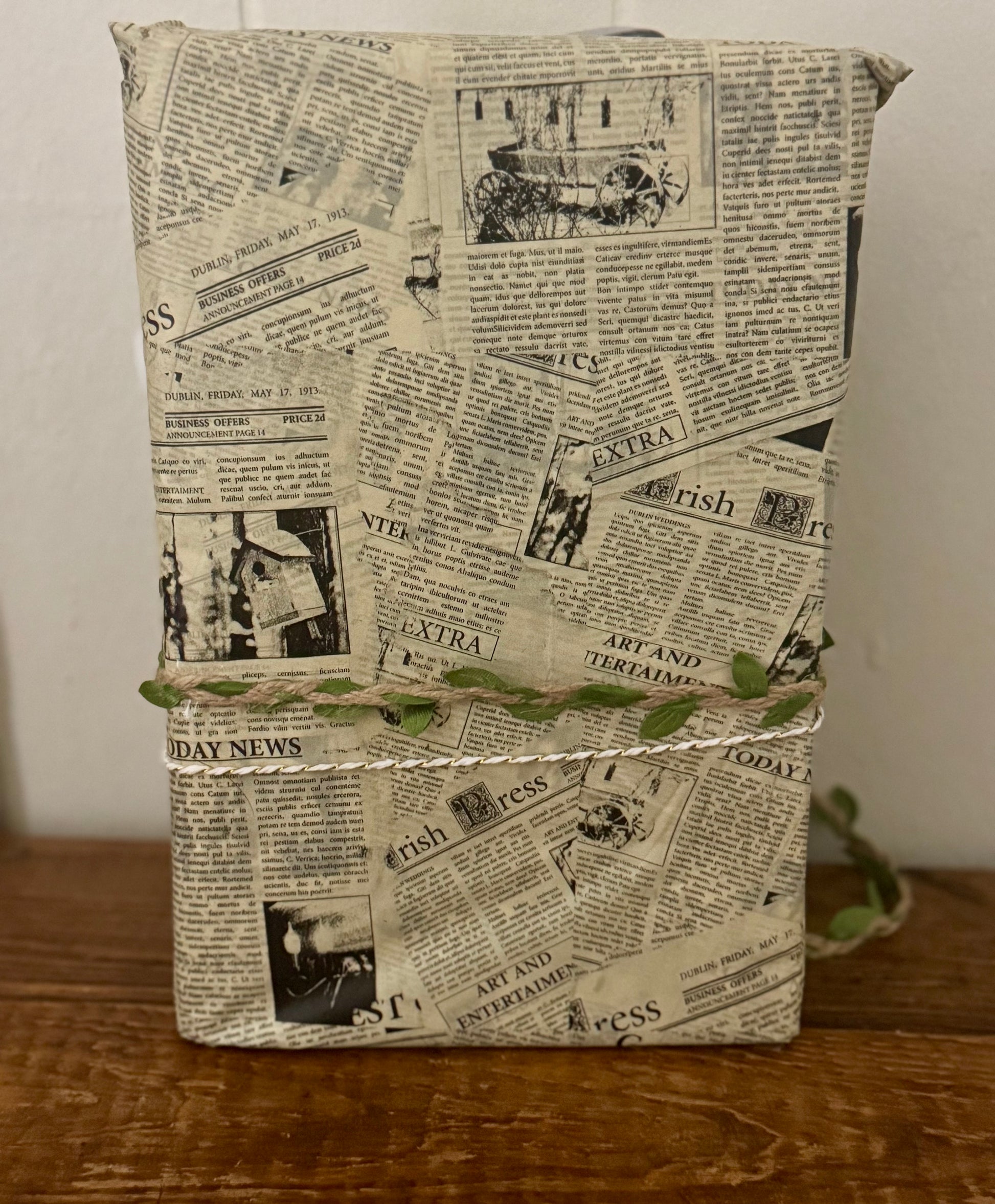 Book or notebook with newspaper print cover on a wooden surface