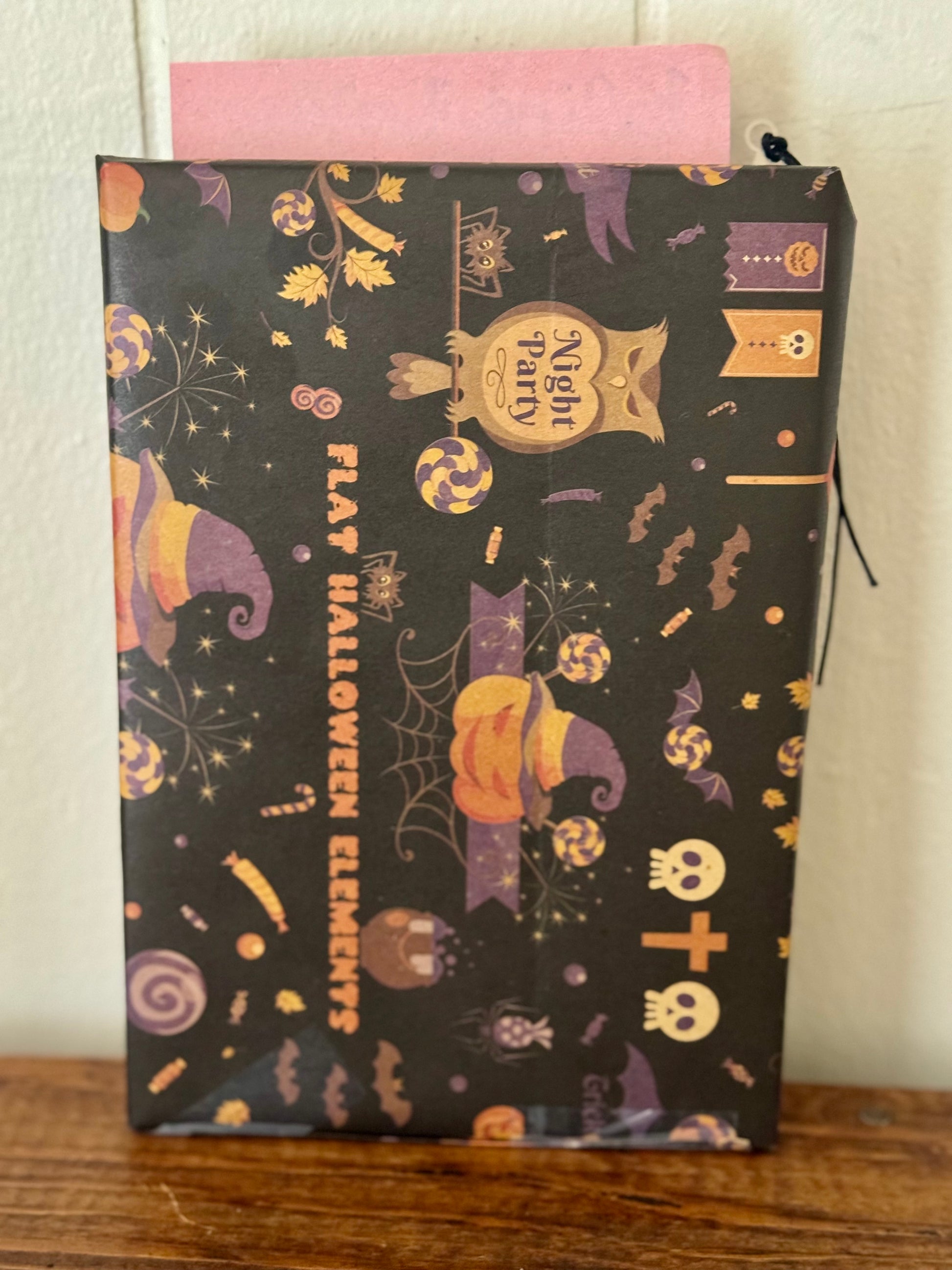 Halloween-themed pouch with decorative patterns on a wooden surface