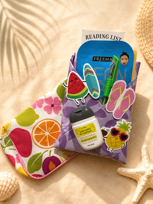 Summer-themed Blind Date with a Book package wrapped in purple floral paper with tropical stickers, reading accessories, and beach-inspired bookish extras