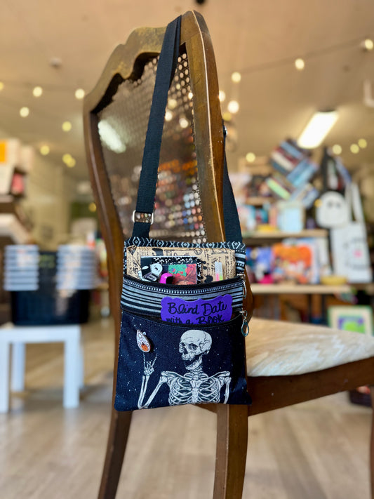 Small bag with skeleton design on a chair in a store setting