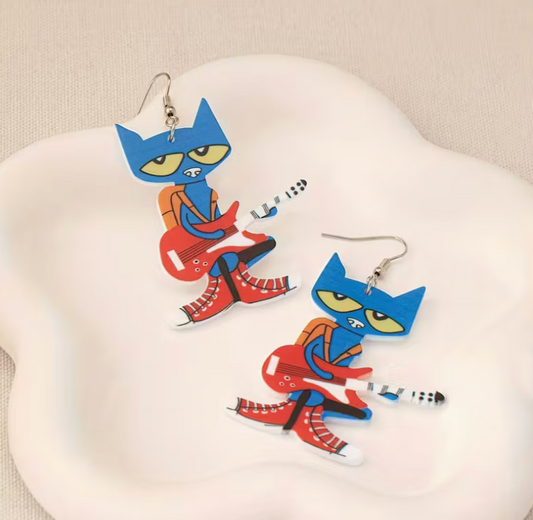 blue cat acrylic earrings featuring a cartoon cat playing a red guitar with colorful dangle design