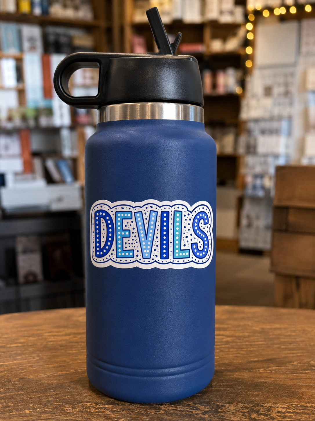 Blue Devils 3 inch vinyl sticker with colorful blue DEVILS lettering displayed on a navy water bottle