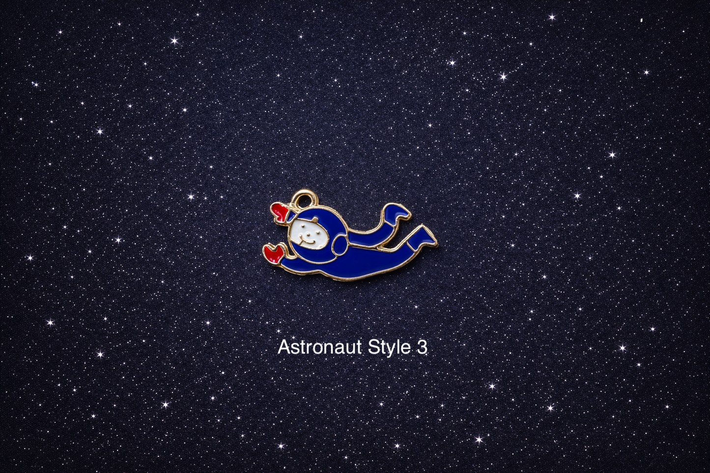 Blue flying astronaut enamel charm with red gloves and gold outline, shown on a dark starry background and sold individually.