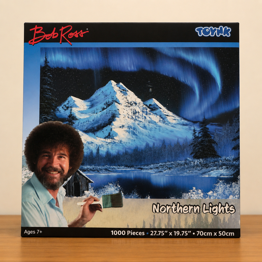 Bob Ross Northern Lights 1000-piece jigsaw puzzle featuring a colorful nighttime landscape scene with glowing northern lights and peaceful nature artwork