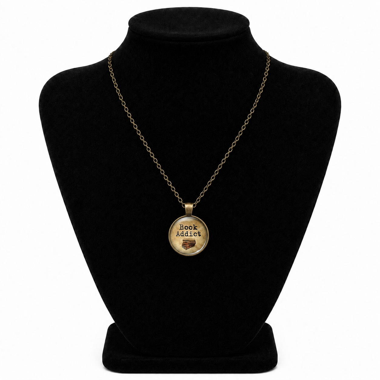 Vintage bronze-tone Book Addict necklace with round glass pendant, stacked book design, and matching chain.