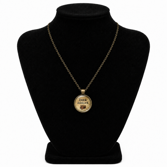 Vintage bronze-tone Book Addict necklace with round glass pendant, stacked book design, and matching chain.