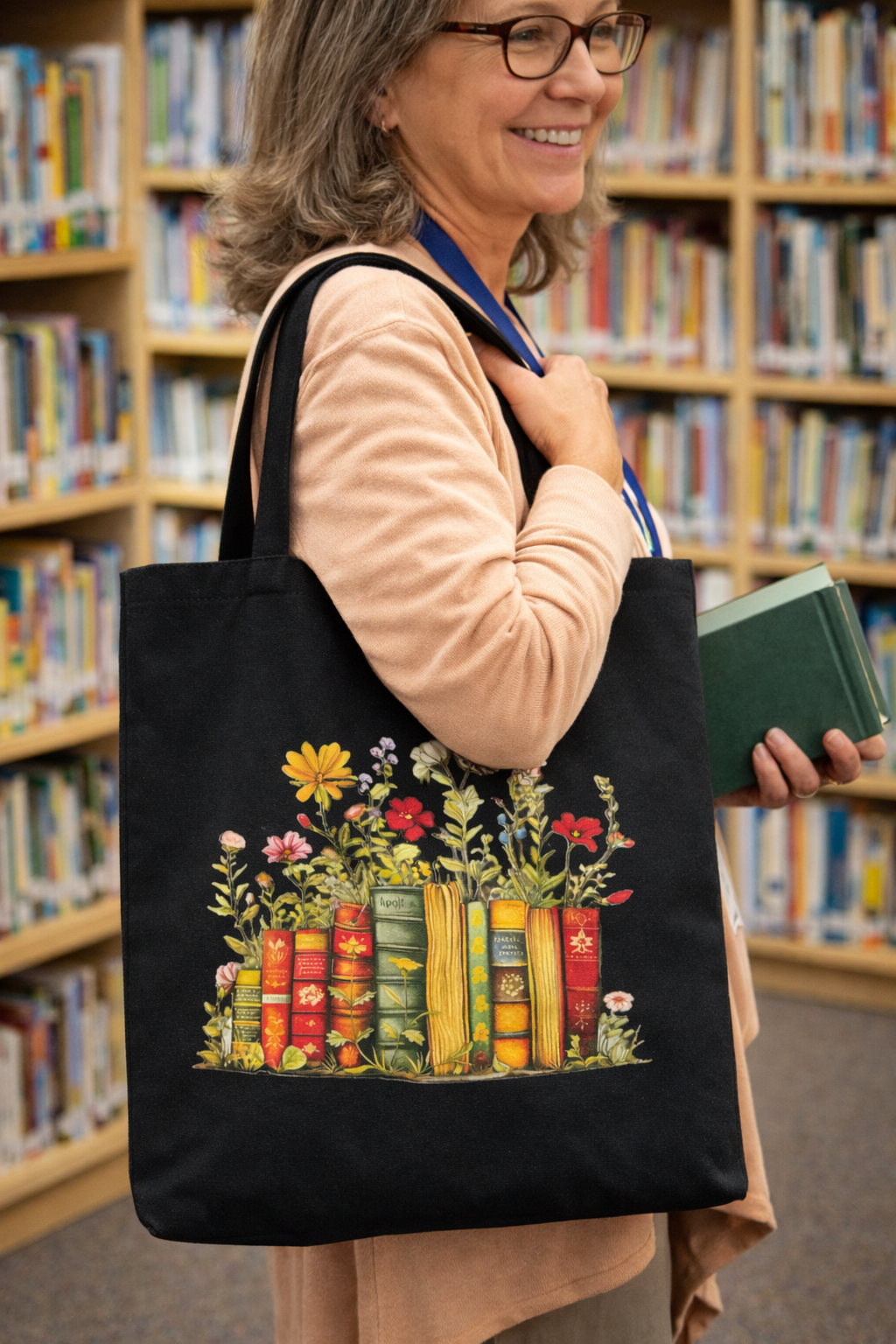 Woman in library carrying black tote bag with colorful vintage books and wildflowers design while holding books in hand