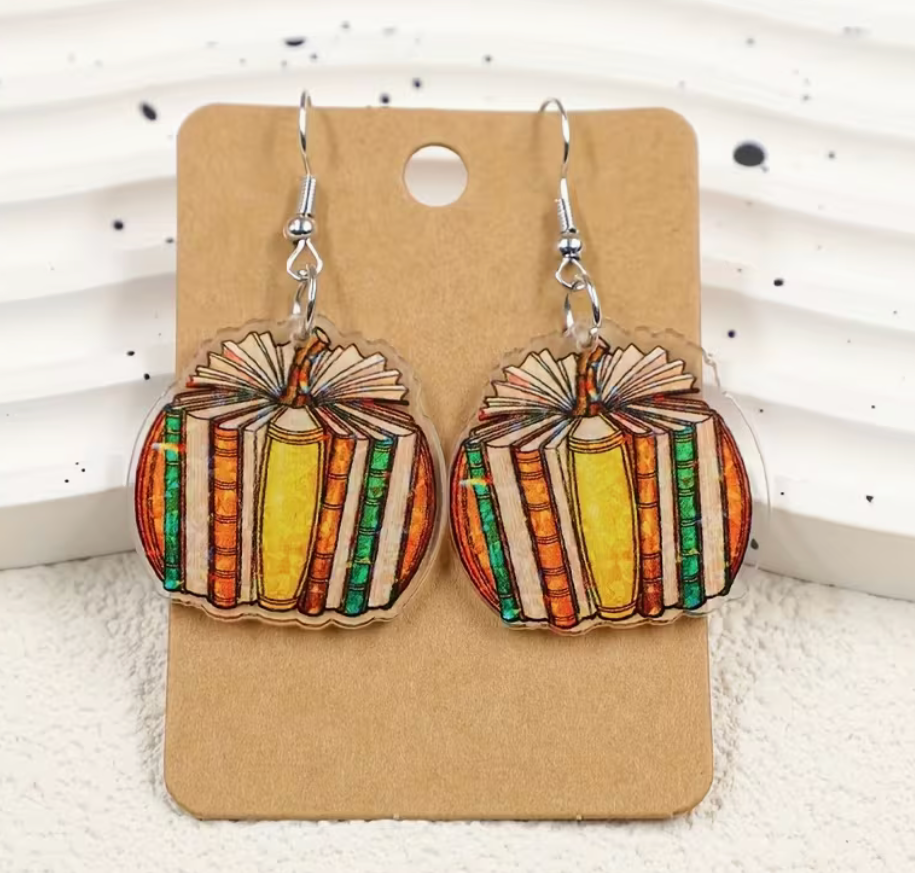 Colorful book pumpkin acrylic dangle earrings featuring vintage-style books arranged in a pumpkin shape