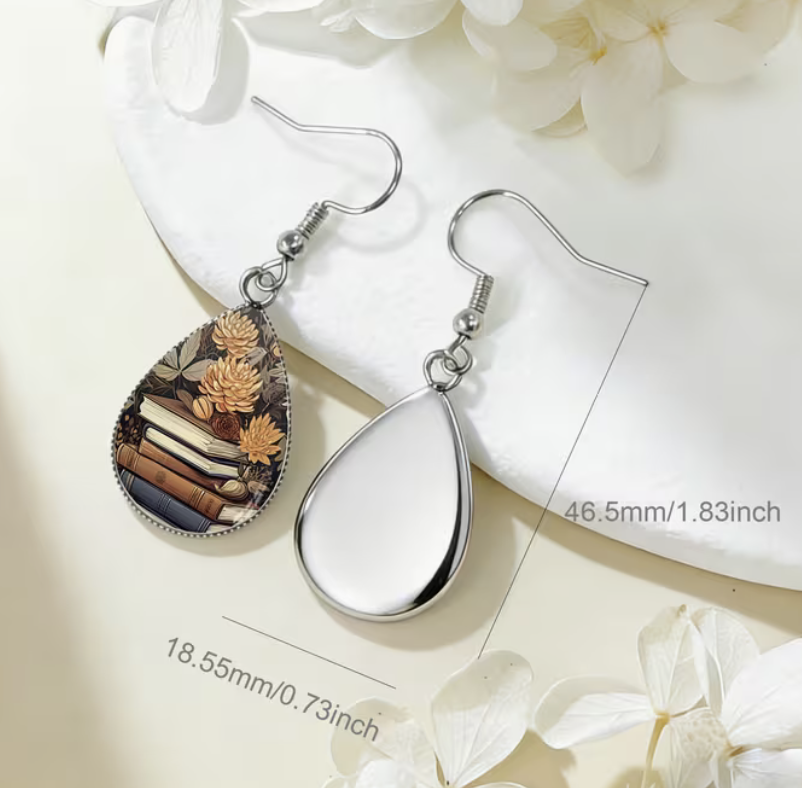 Book stack and golden flower teardrop glass earring with silver-tone hook measuring approximately 1.83 inches long