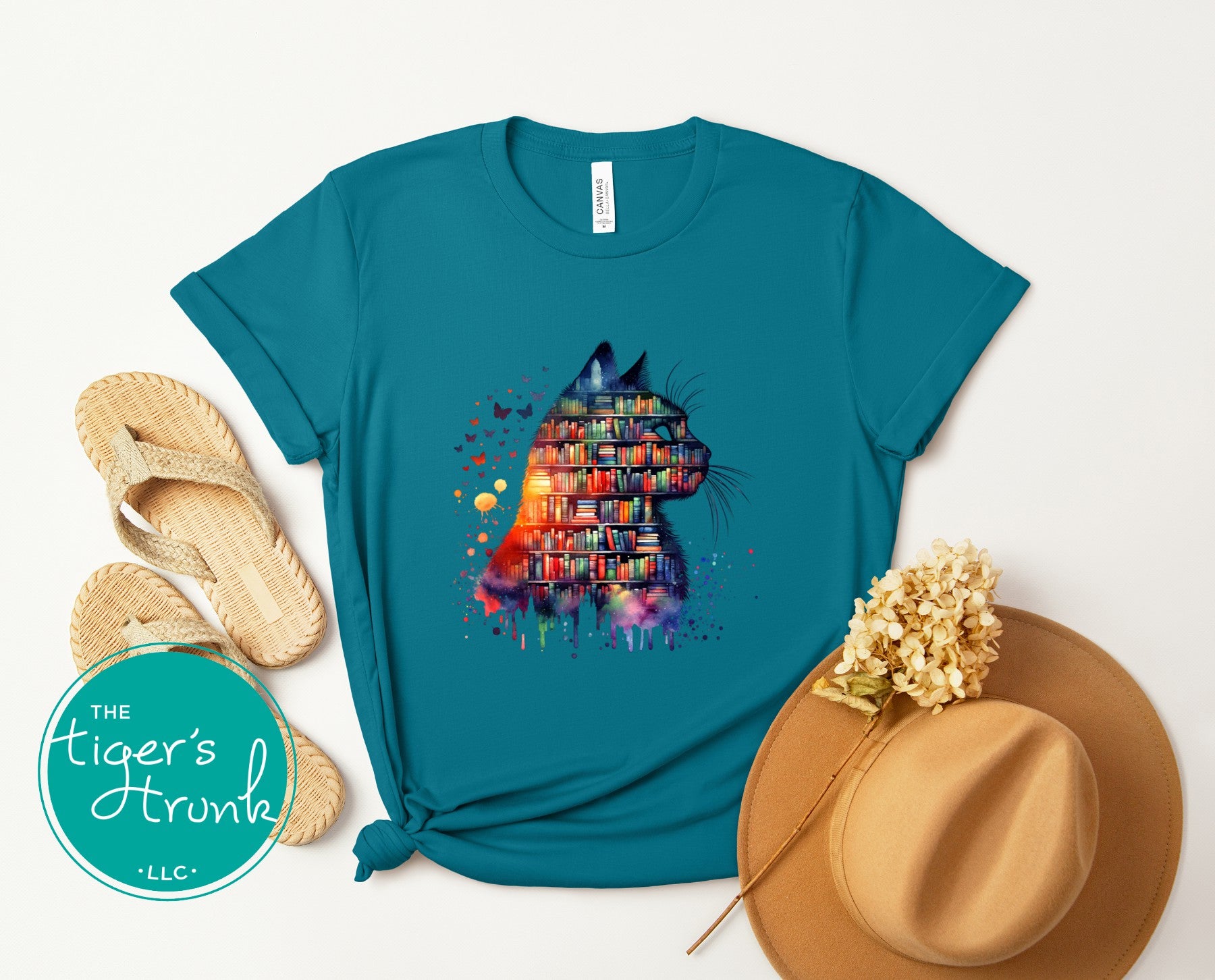 Teal unisex shirt with a watercolor cat silhouette filled with colorful books