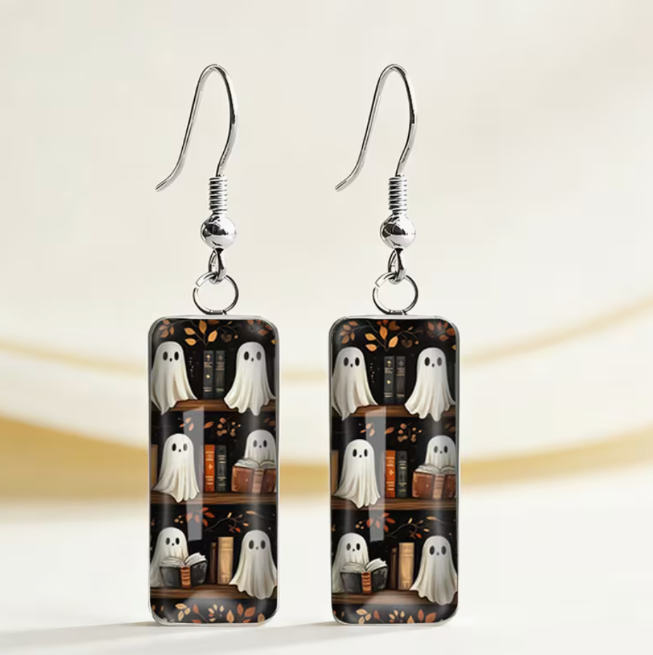 Rectangular Halloween dangle earrings featuring cute white ghosts among old books on dark bookshelves