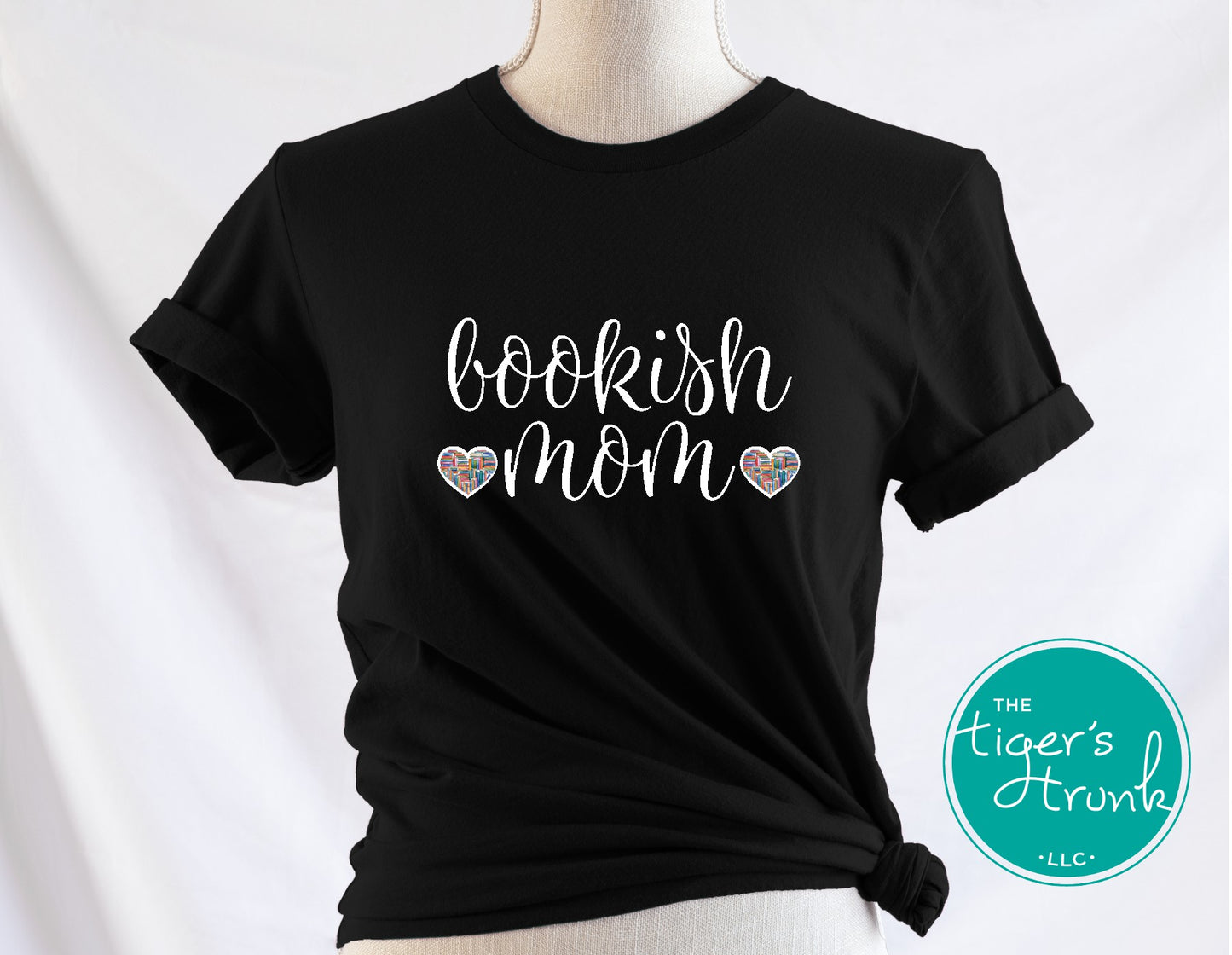 Black t-shirt with 'bookish mom' text on a mannequin against a white background, featuring the brand 'The Tiger's Trunk'.