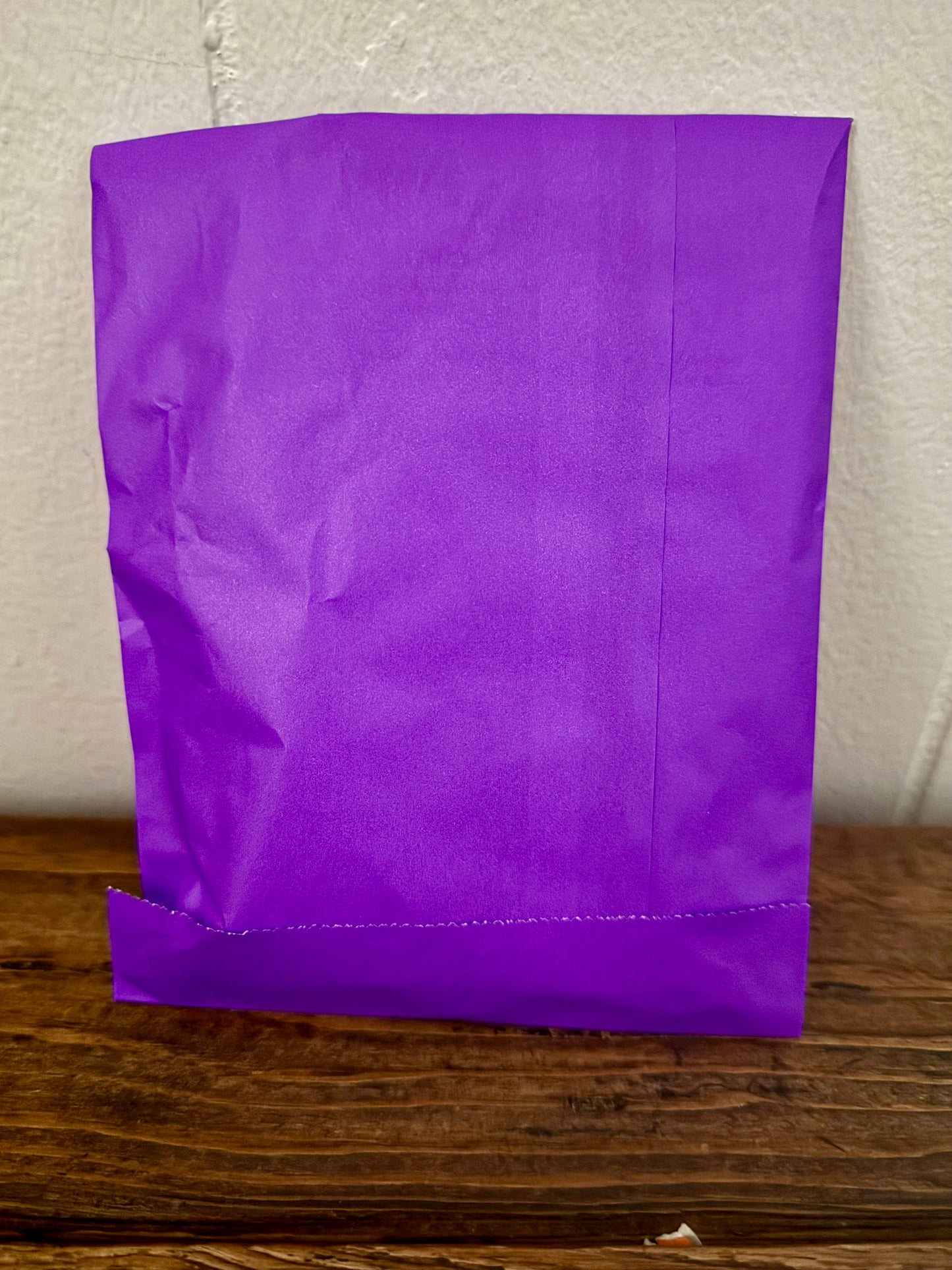 Purple bookish surprise bag featuring assorted literary treats and small mystery goodies for book lovers.