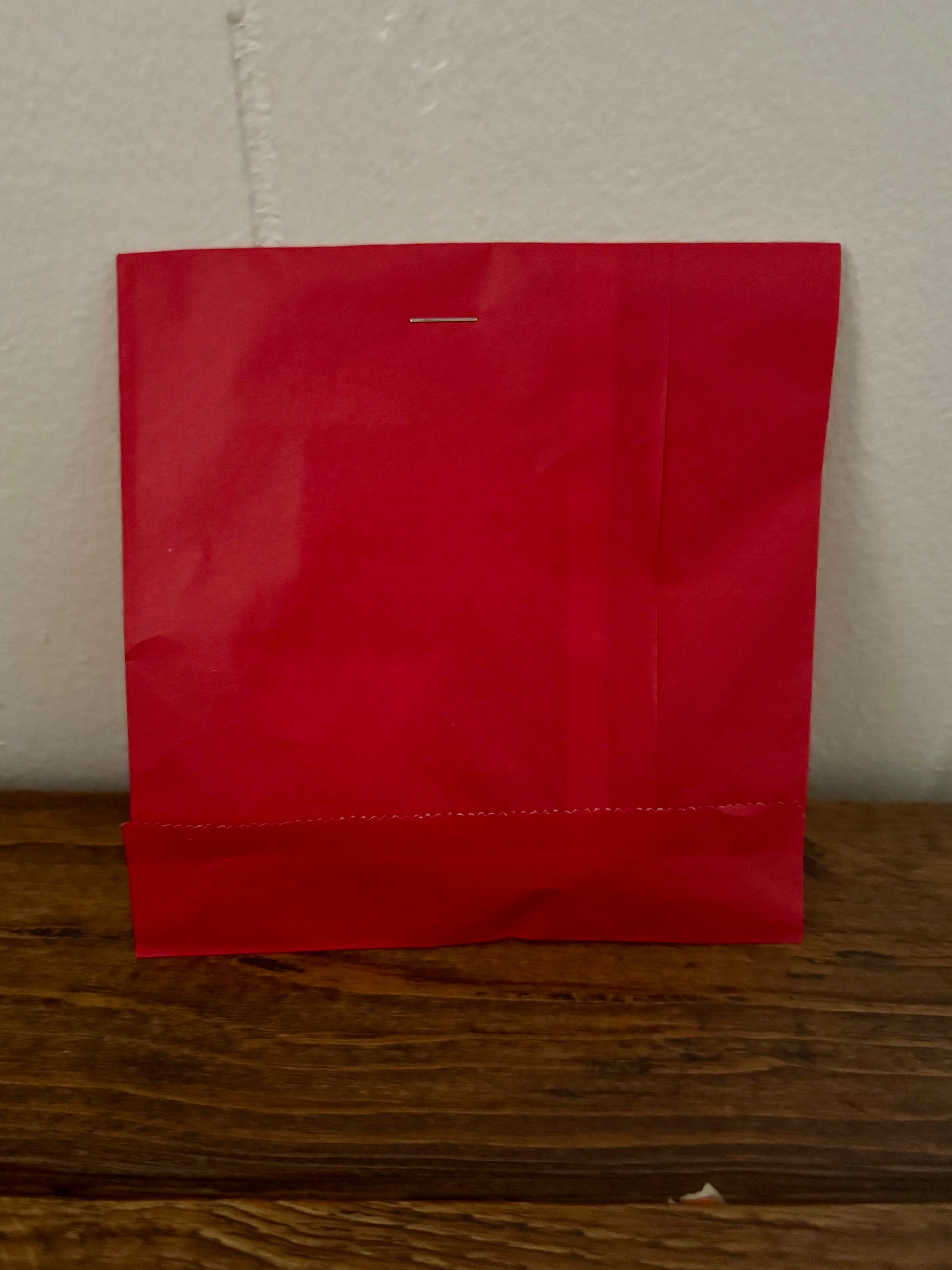 Red bookish surprise bag packed with cute reader-themed surprises and blind date style gifts.