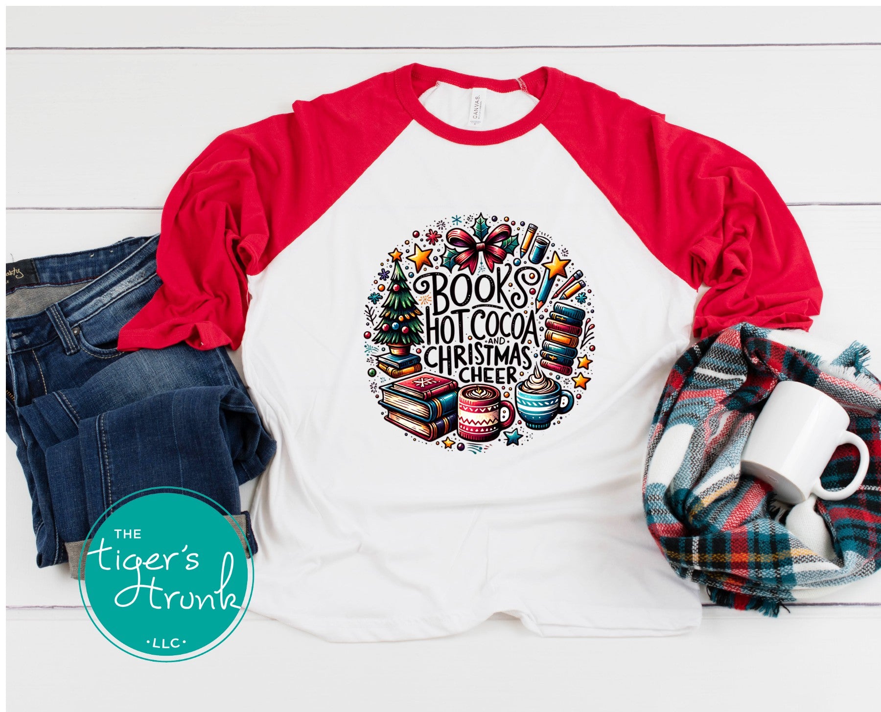 White and red raglan t-shirt with Books Hot Cocoa and Christmas Cheer design, displayed with jeans, scarf, and mug.