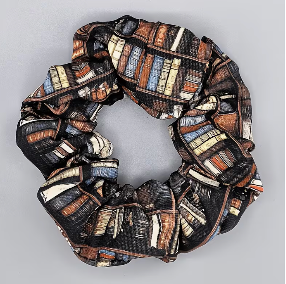 Bookish fabric scrunchie featuring a vintage bookshelf print with rows of brown cream blue and black books