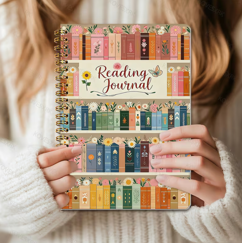 Reading Journal with colorful bookshelf design held by a person wearing a white sweater.