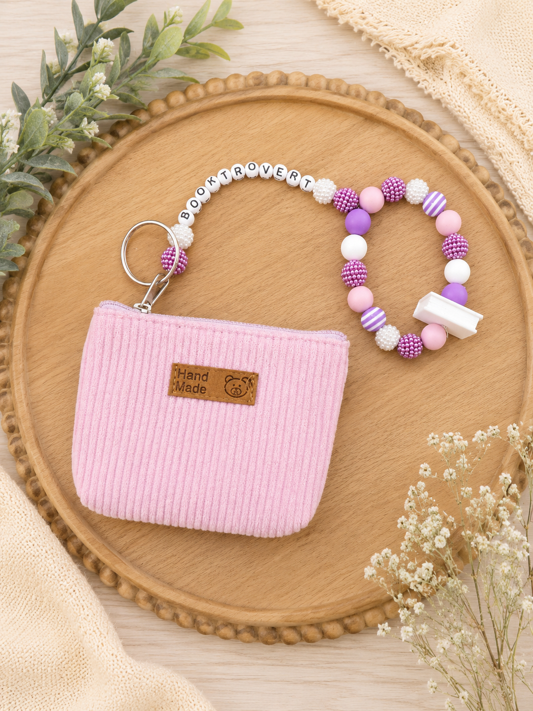 Booktrovert beaded wristlet keychain with pink zipper pouch and purple pink and white beads