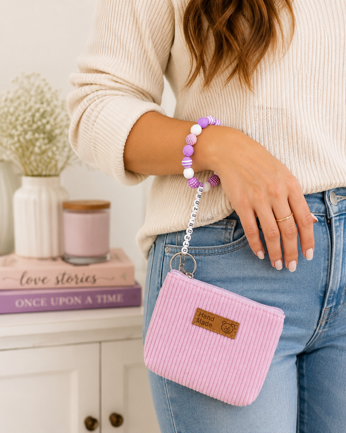 Booktrovert pink and purple beaded wristlet keychain with mini pouch worn on wrist