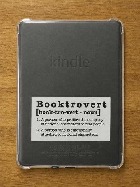 White die cut Booktrovert definition sticker displayed on the back of a Kindle e-reader.