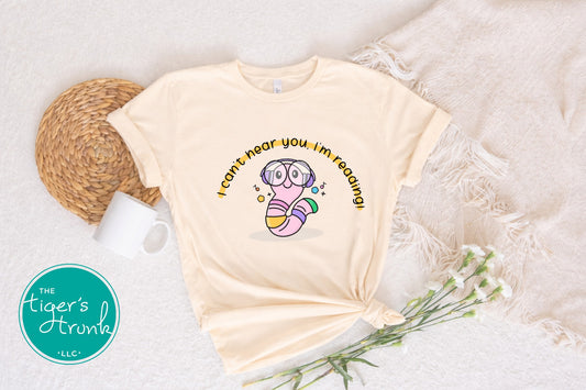Cream t-shirt with printed design on a textured surface, featuring 'The Tiger's Trunk' logo.