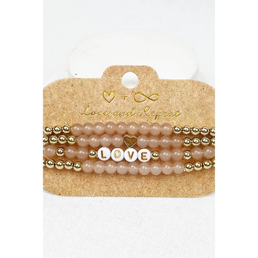 Handmade beaded bracelet with colorful beads and the word "LOVE" spelled out in white letter beads, perfect for casual wear or gifting.