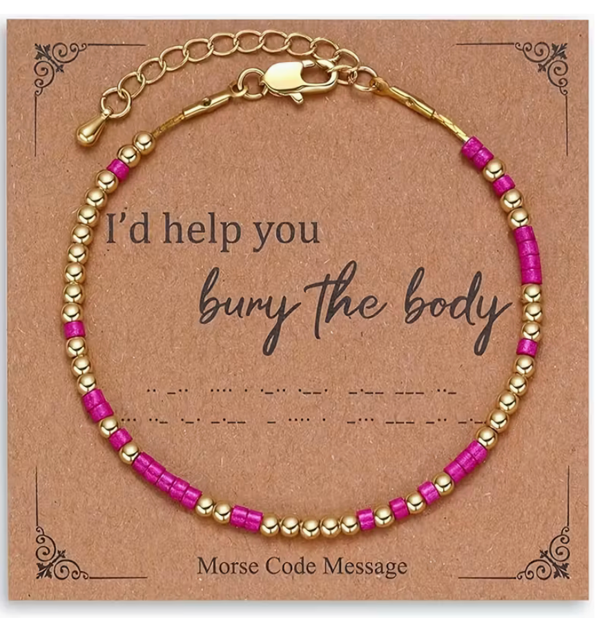 Pink and gold Morse code bracelet displayed on a kraft message card that reads I’d help you bury the body.