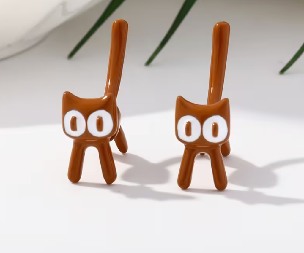 Brown cat stud earrings with exaggerated cartoon-inspired features