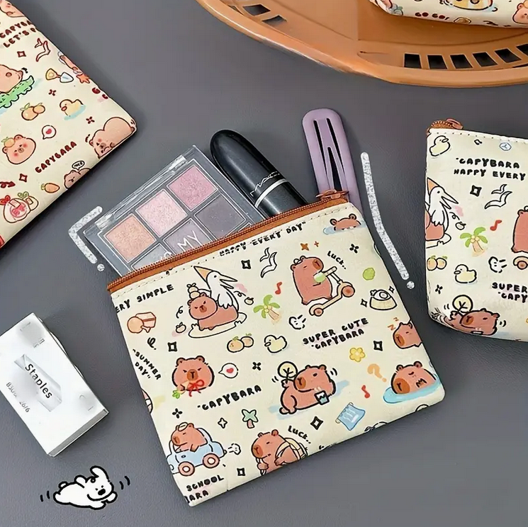 Cute patterned pouch with cosmetic items on a gray surface