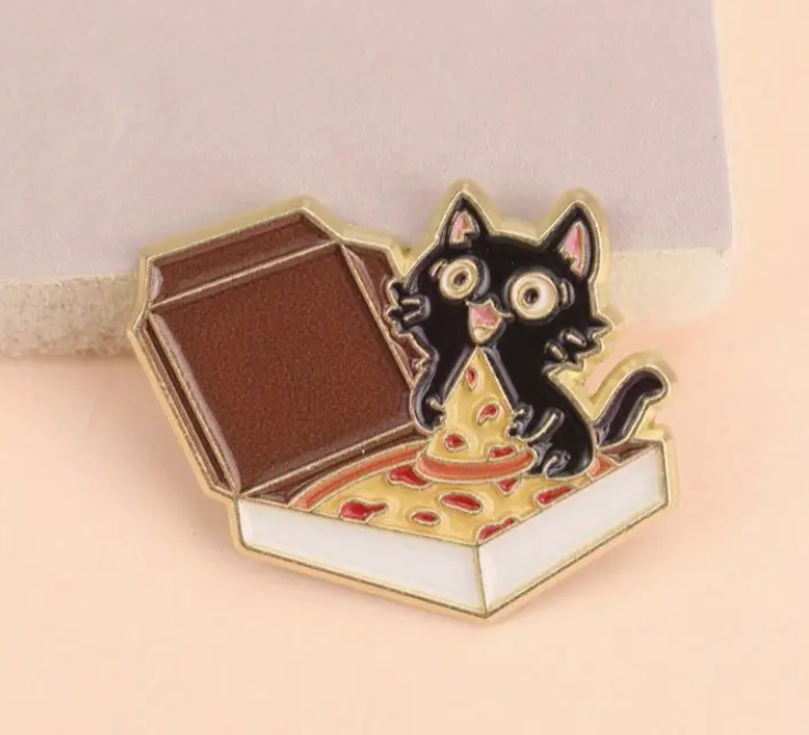 Cat and Pizza enamel pin featuring a black cat holding a slice of pizza inside a pizza box, cute and funny accessory for cat and food lovers