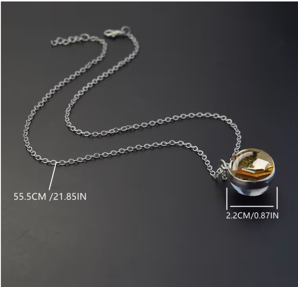 Cat reading book glass ball necklace showing 21.85-inch chain and 0.87-inch pendant measurements.