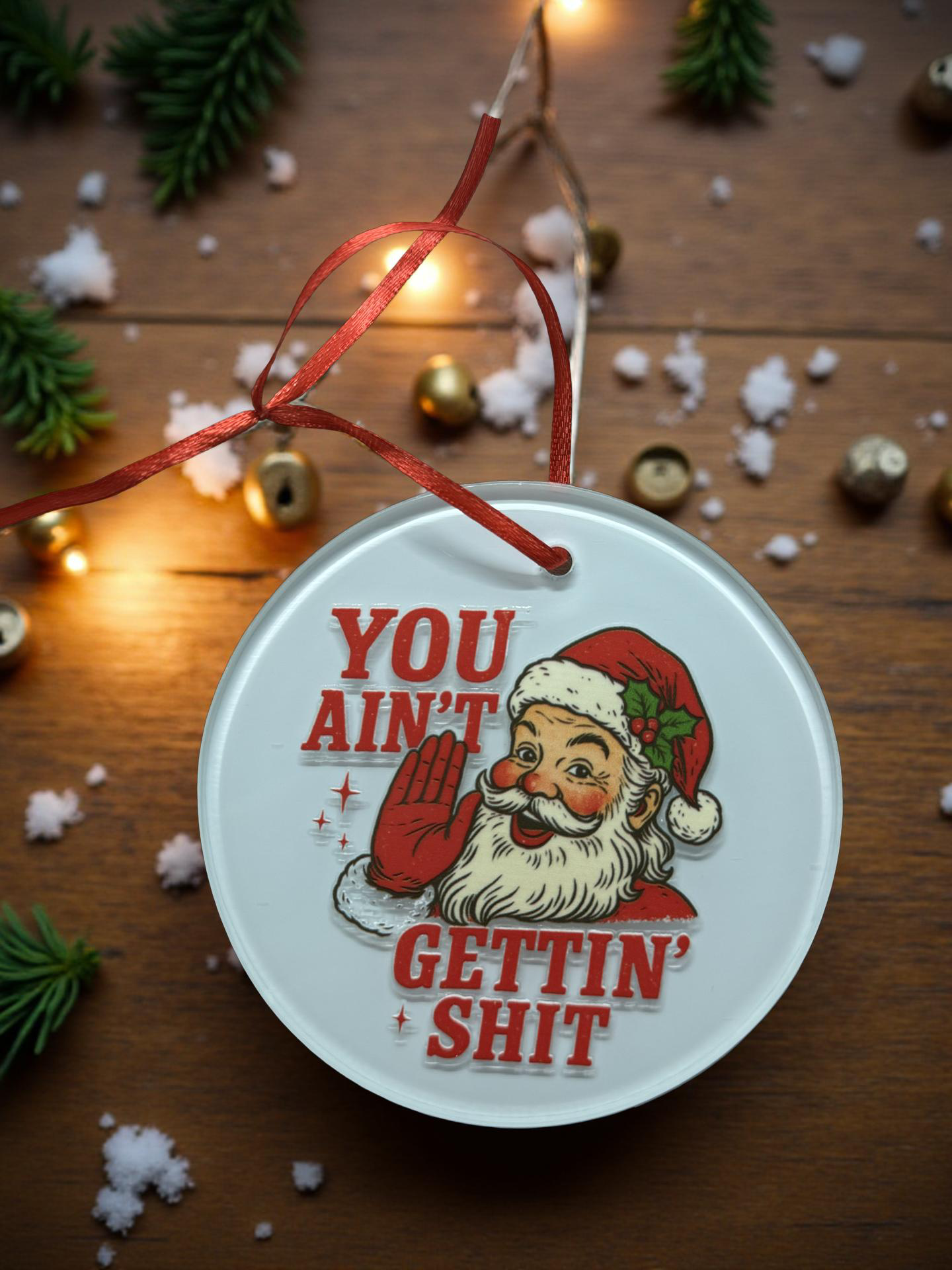 4-inch ceramic ornament with vintage Santa and bold funny phrase on a wooden background with lights