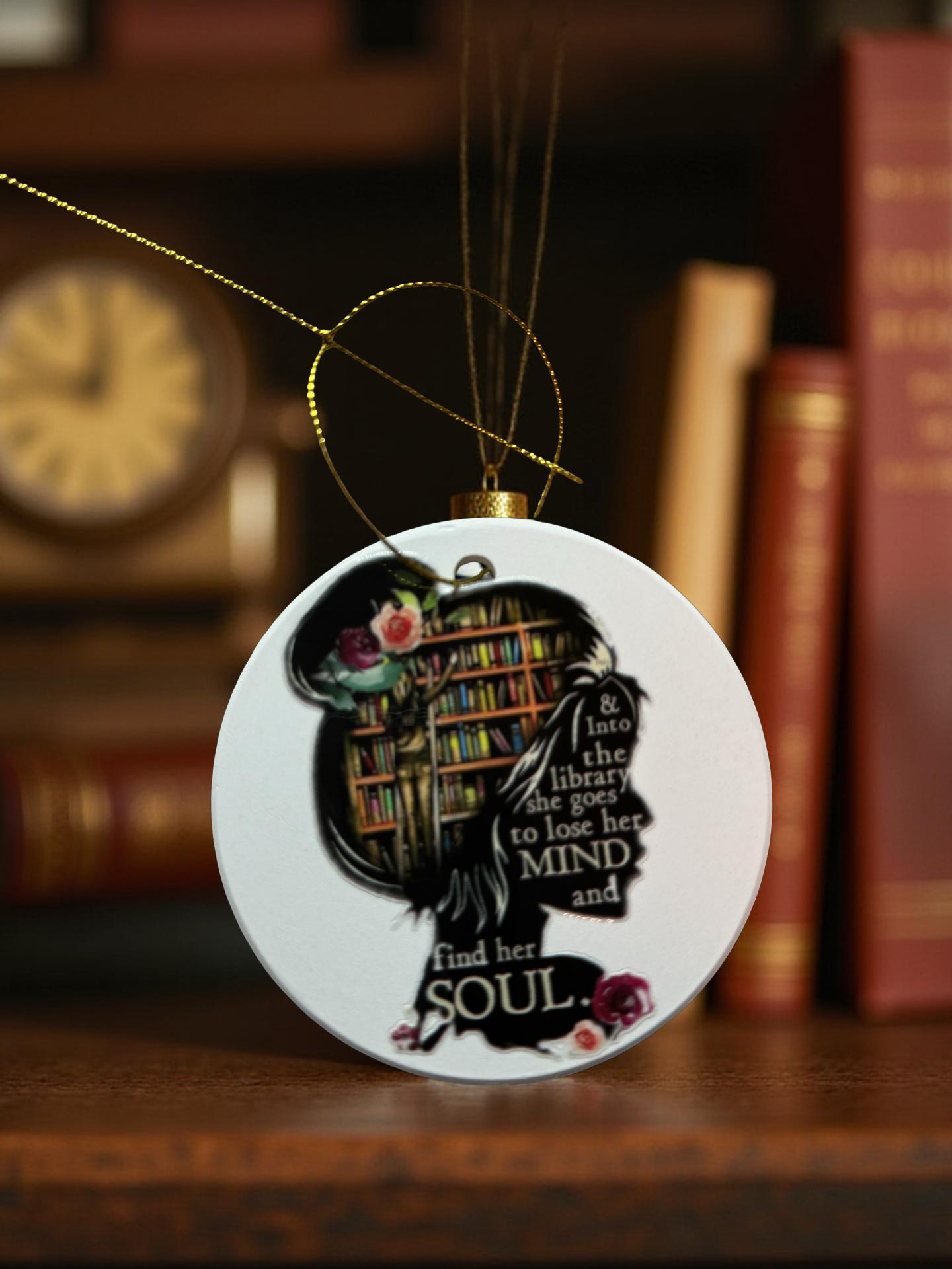 Ceramic ornament with woman’s silhouette filled with books and quote Into the library she goes to lose her mind and find her soul