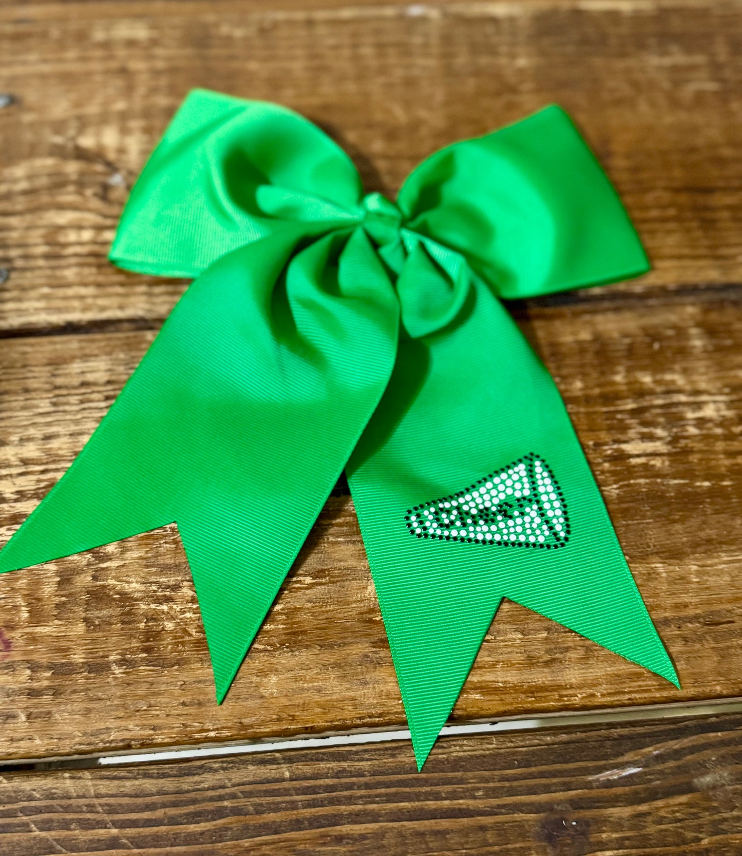 Kelly green cheer bow with a megaphone design and "cheer" text, showcasing school spirit in vibrant colors.