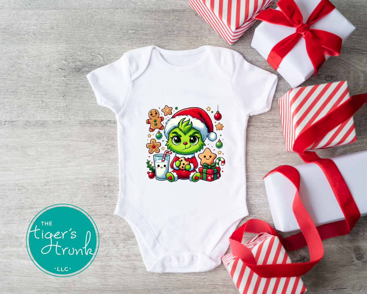 Christmas baby bodysuit featuring a cute green holiday character wearing a Santa hat with cookies, milk, ornaments, candy cane, and presents.