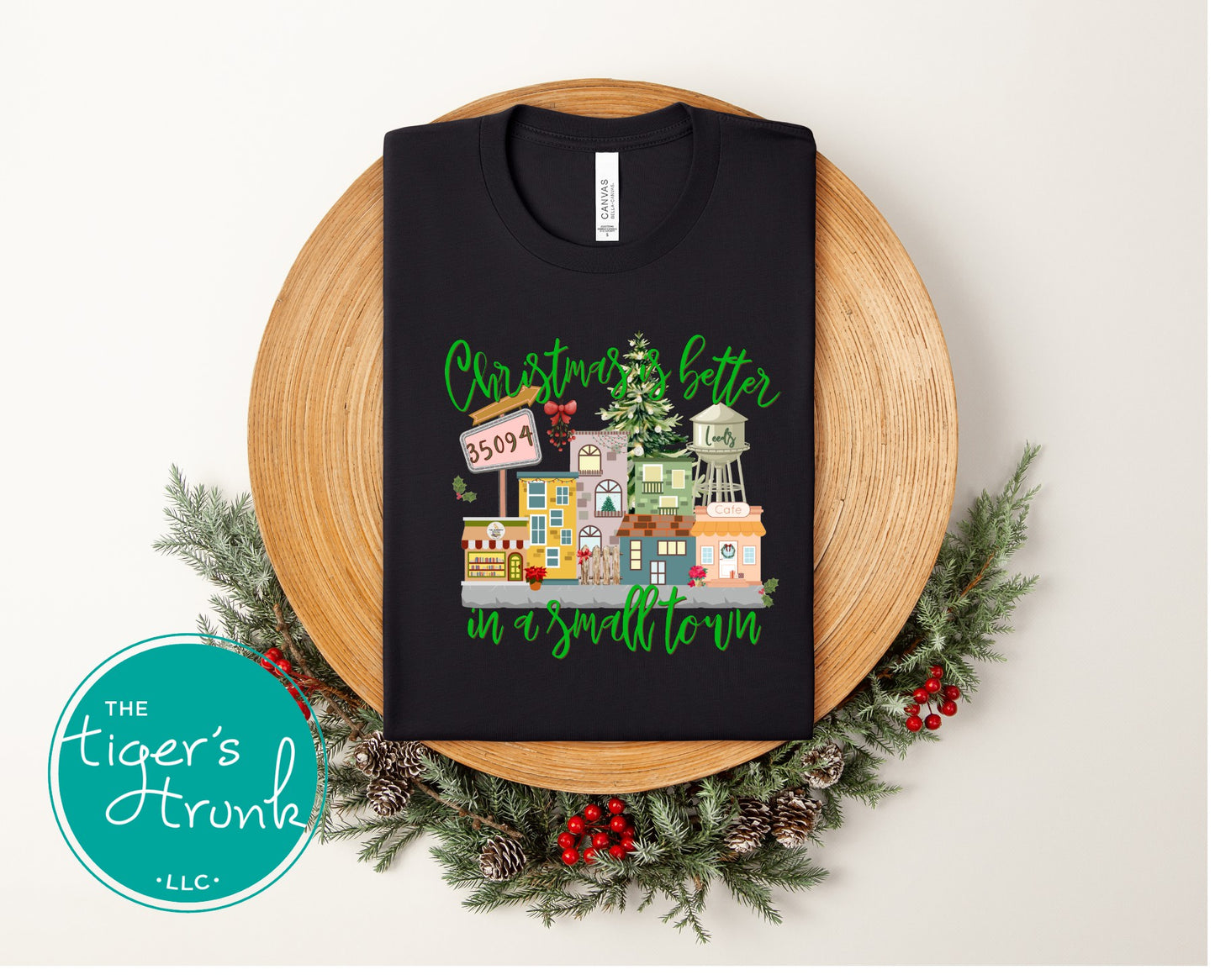 Black Christmas shirt with festive town illustration and Christmas Is Better in a Small Town text.