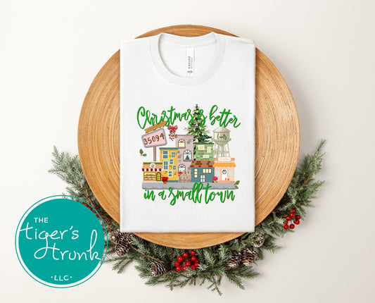 White Christmas shirt with festive small-town graphic and Christmas Is Better in a Small Town message.
