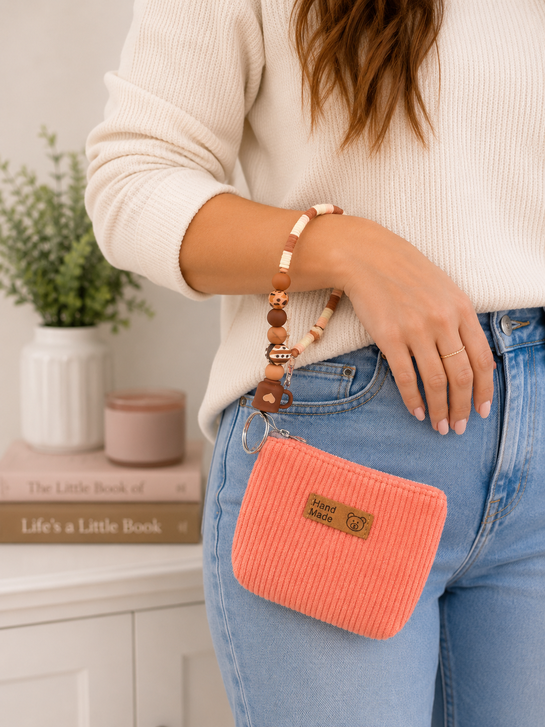 Coffee themed brown and cream beaded wristlet keychain with coral mini pouch worn on wrist