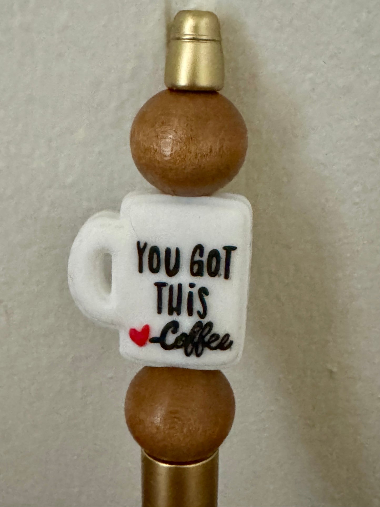 Decorative bottle stopper with a coffee mug design and text on a neutral background