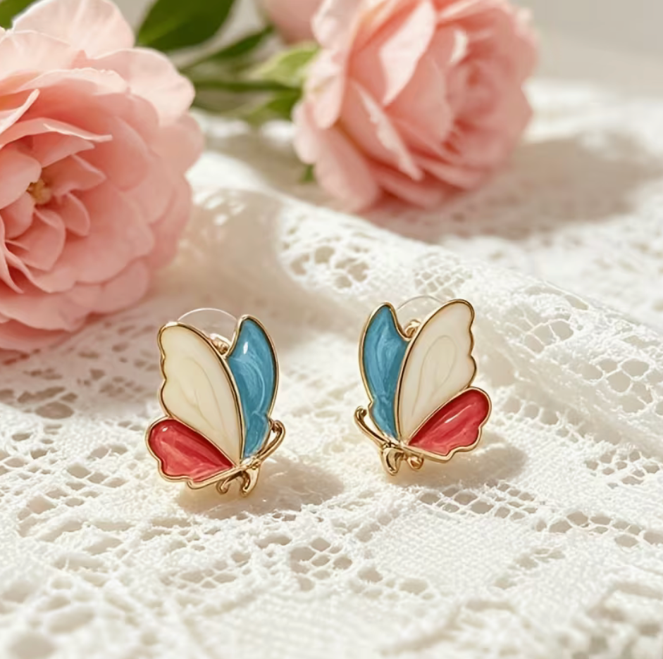 Colorful butterfly stud earrings with ivory turquoise blue and coral pink wings outlined in gold tone