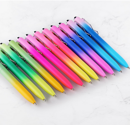 row of colorful gradient pens arranged on white surface
