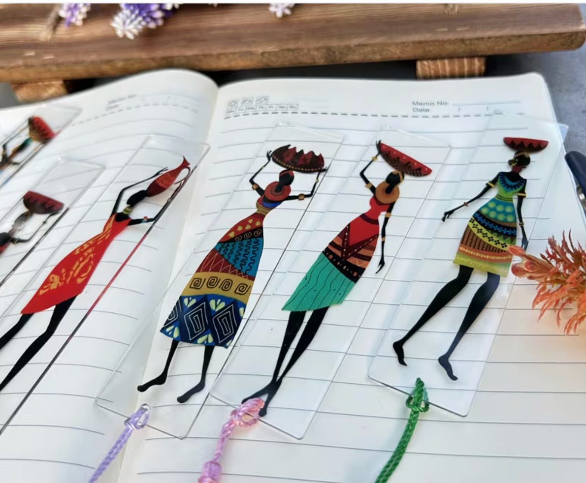 Colorful illustrations of women on a notebook with a wooden surface in the background