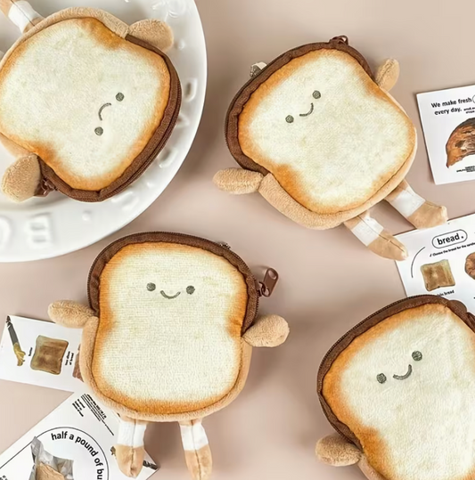 Cute plush toast-shaped coin purse with embroidered smiling face, tiny arms and legs, and zipper closure, approximately 4.5 by 4 inches