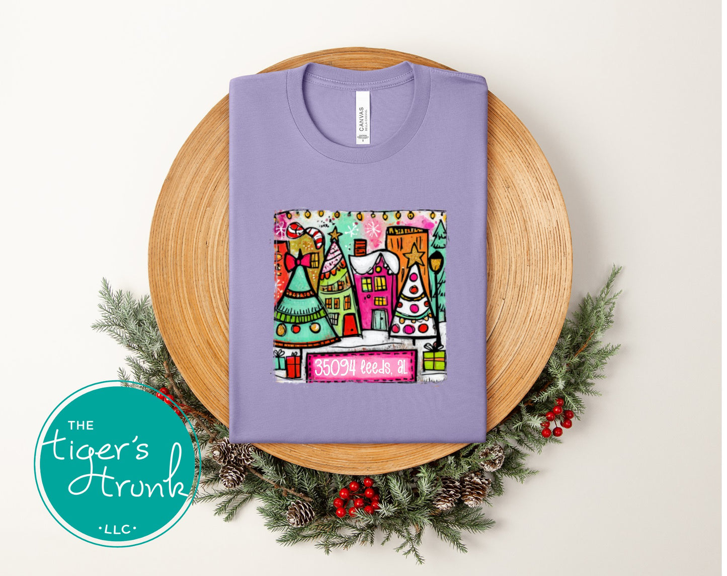 Dark lavender Christmas shirt featuring a colorful holiday village and the zip code 35094 Leeds AL.