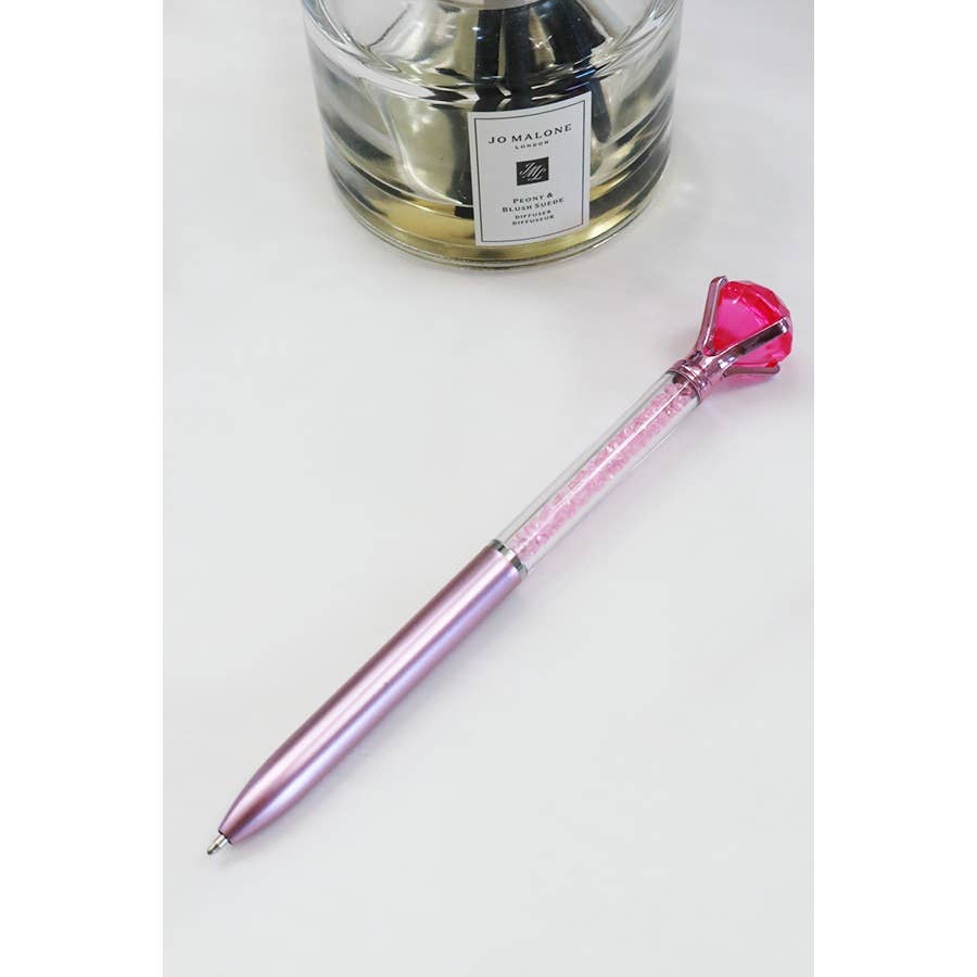 Glittery fun pen topped with a large faux diamond, perfect for writing, journaling, or gifting to kids and teens.