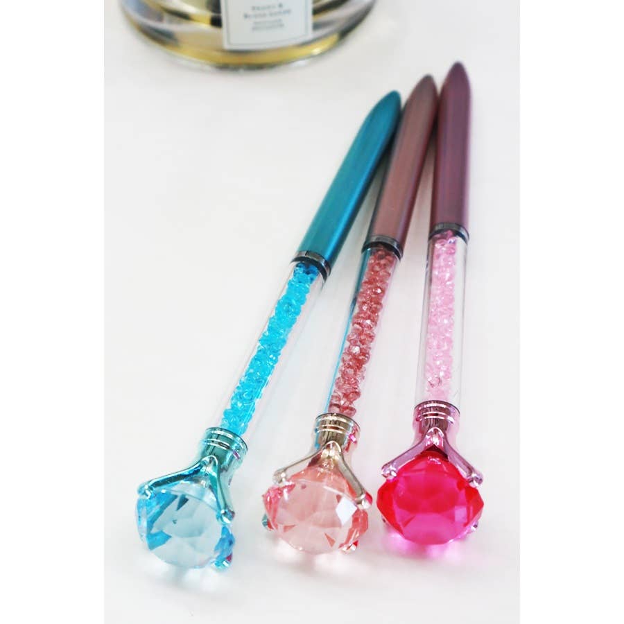 Glittery fun pen topped with a large faux diamond, perfect for writing, journaling, or gifting to kids and teens.