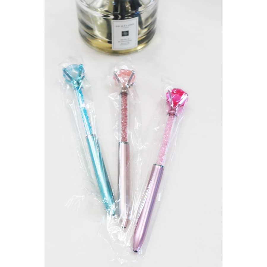 Glittery fun pen topped with a large faux diamond, perfect for writing, journaling, or gifting to kids and teens.