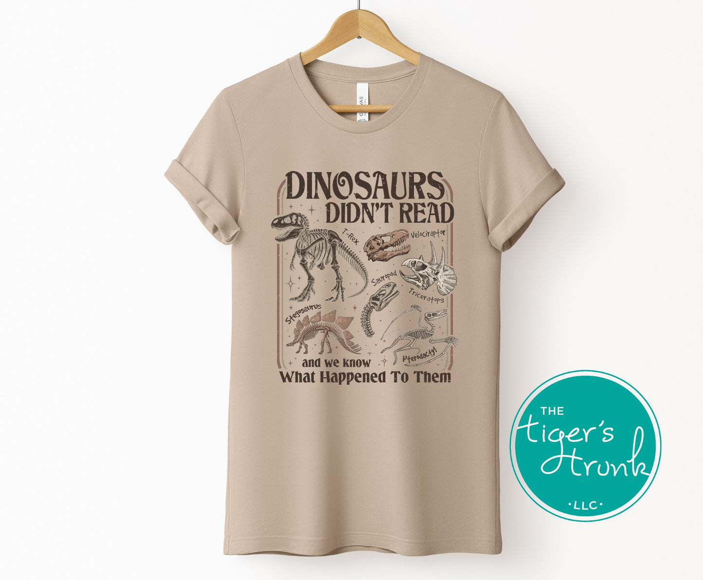 Tan graphic dinosaur shirt with fossil skeleton artwork and funny reading themed quote for book lovers and teachers